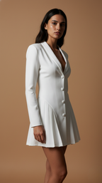 Woman wearing a white blazer dress against a beige background